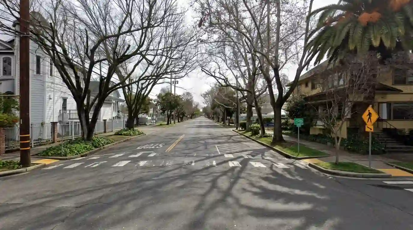 Tree lined residential street in Sacramento with dappled shade