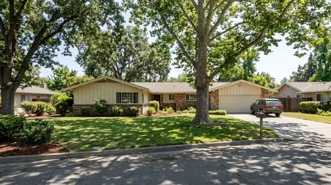 Mid century ranch home with a large front lawn and trees in Arden Arcade California