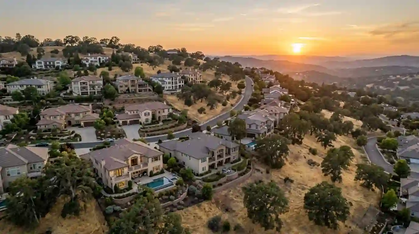 Large hillside homes with oak trees in El Dorado Hills California at sunset